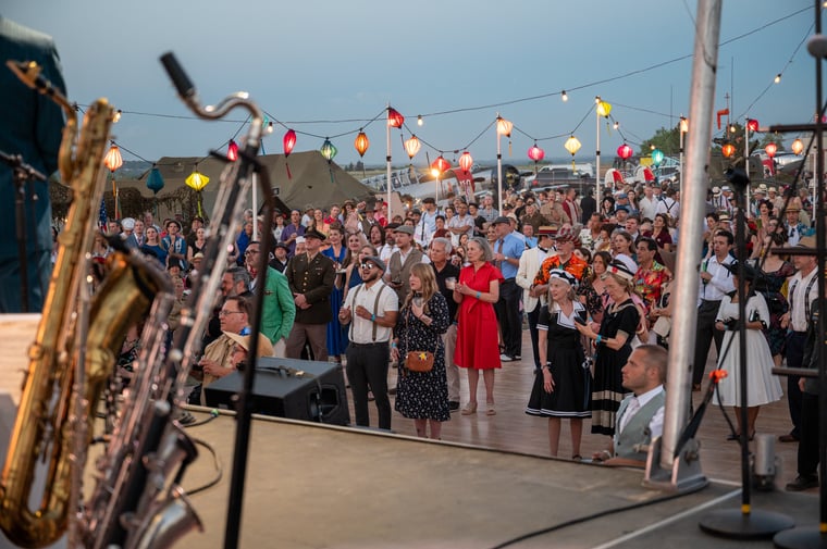 The celebration crowd beneath string lights