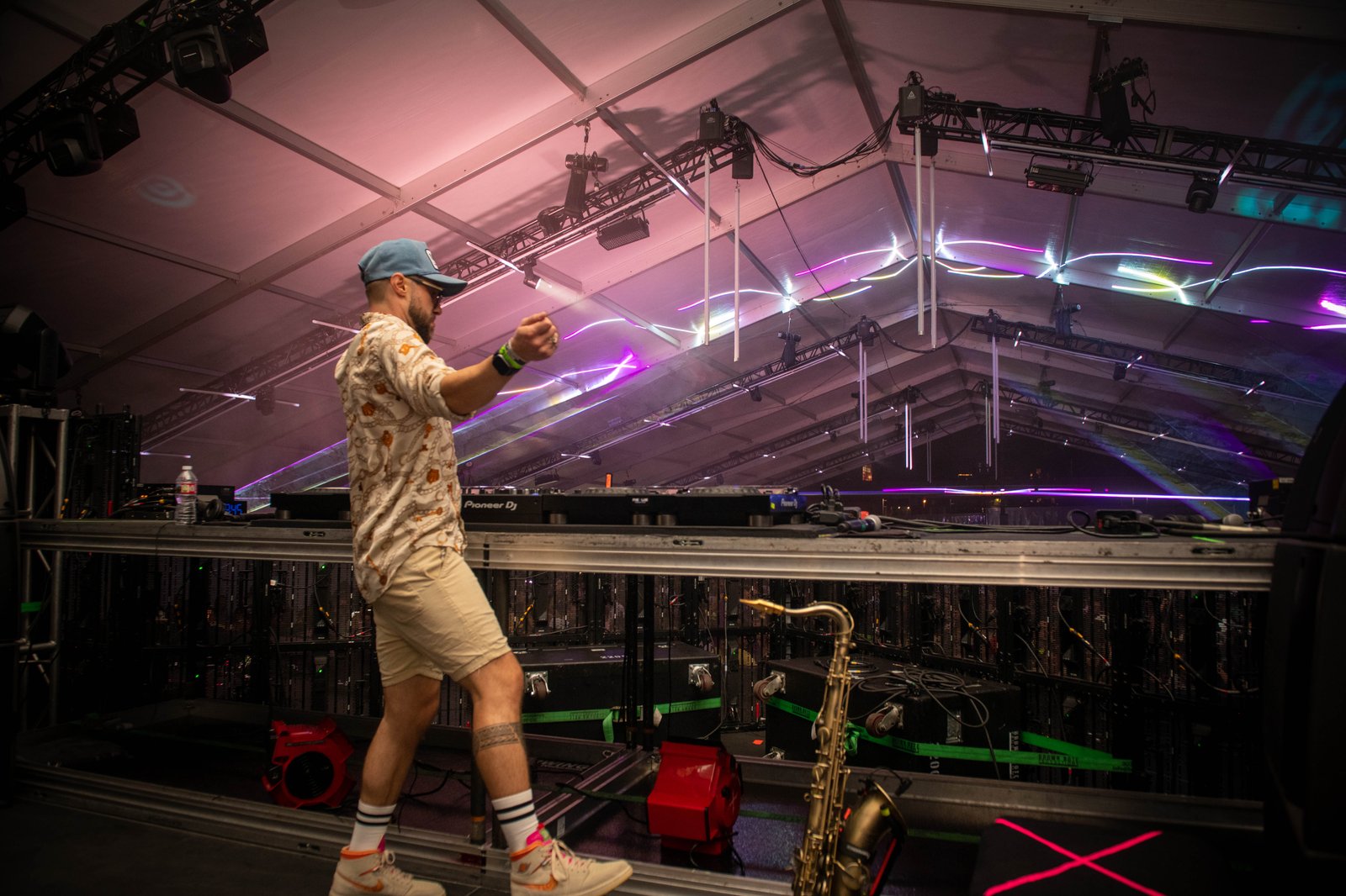 A performer on a produced stage under festival lighting