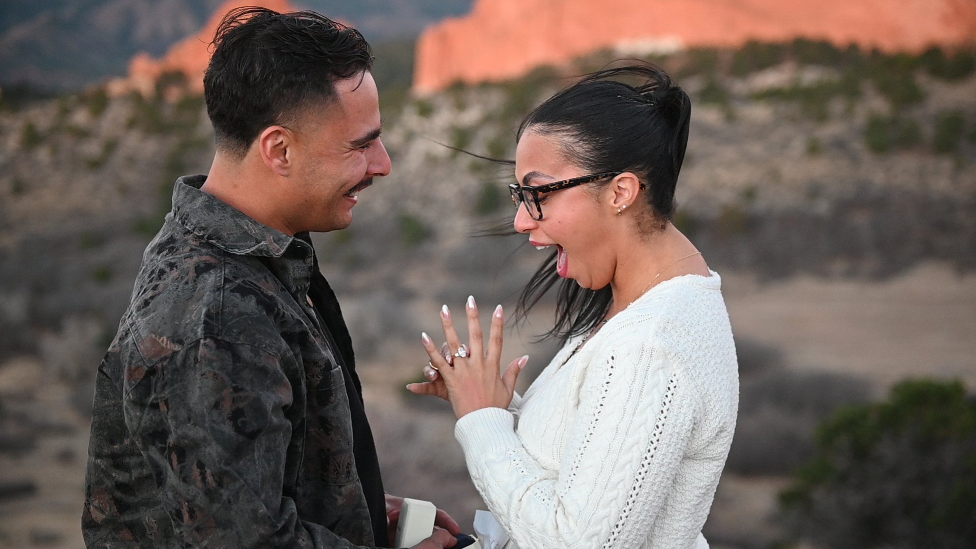 A surprise engagement beneath Colorado red rocks