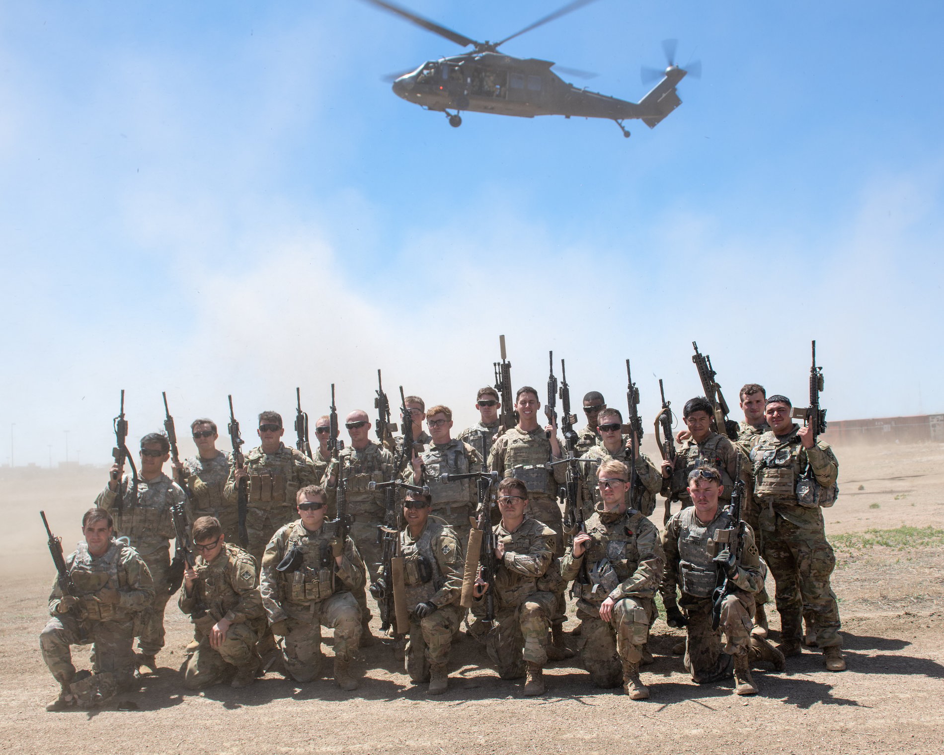 Soldiers before a Black Hawk, captured with respect