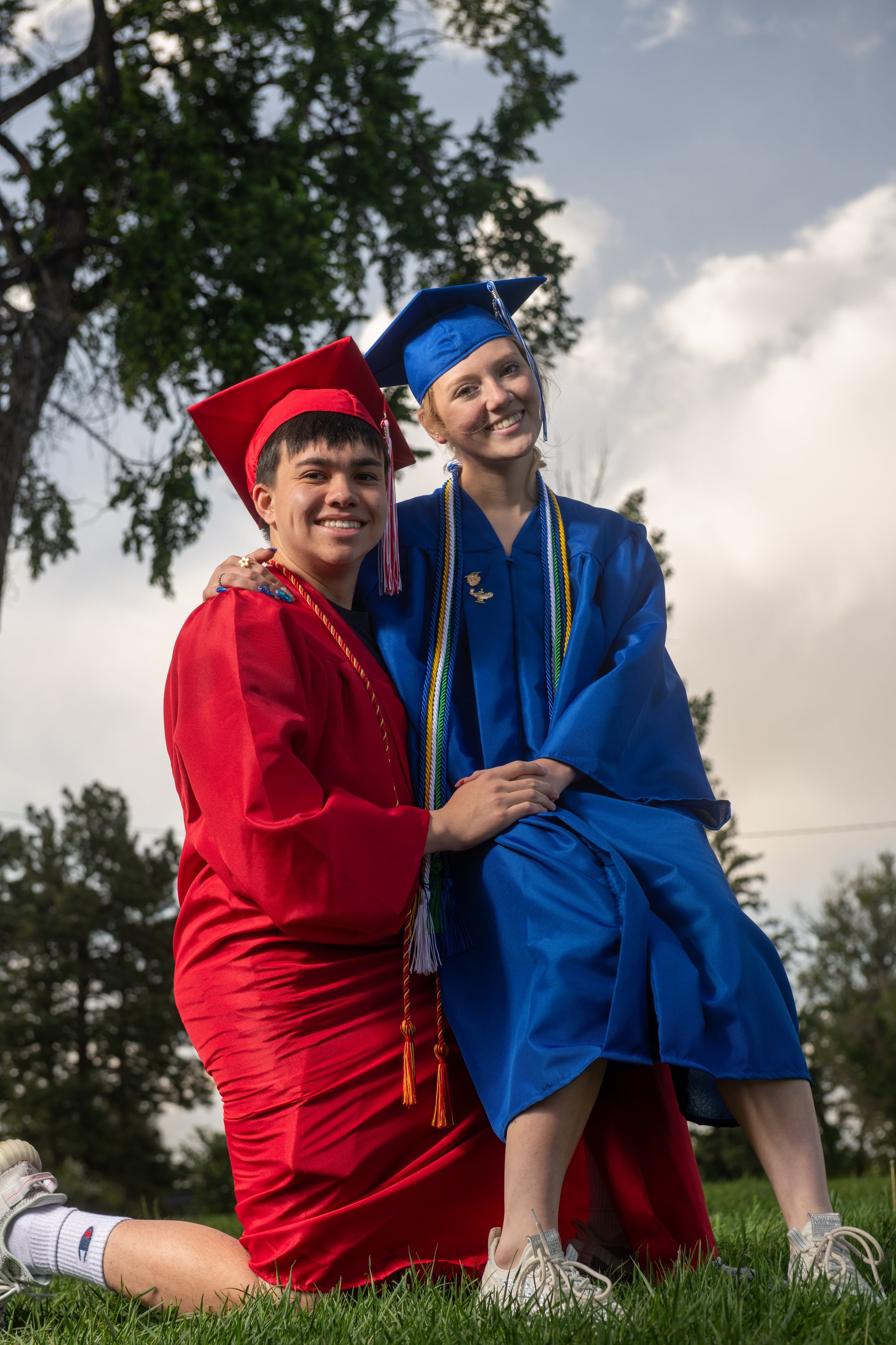 Graduates in cap and gown, side by side