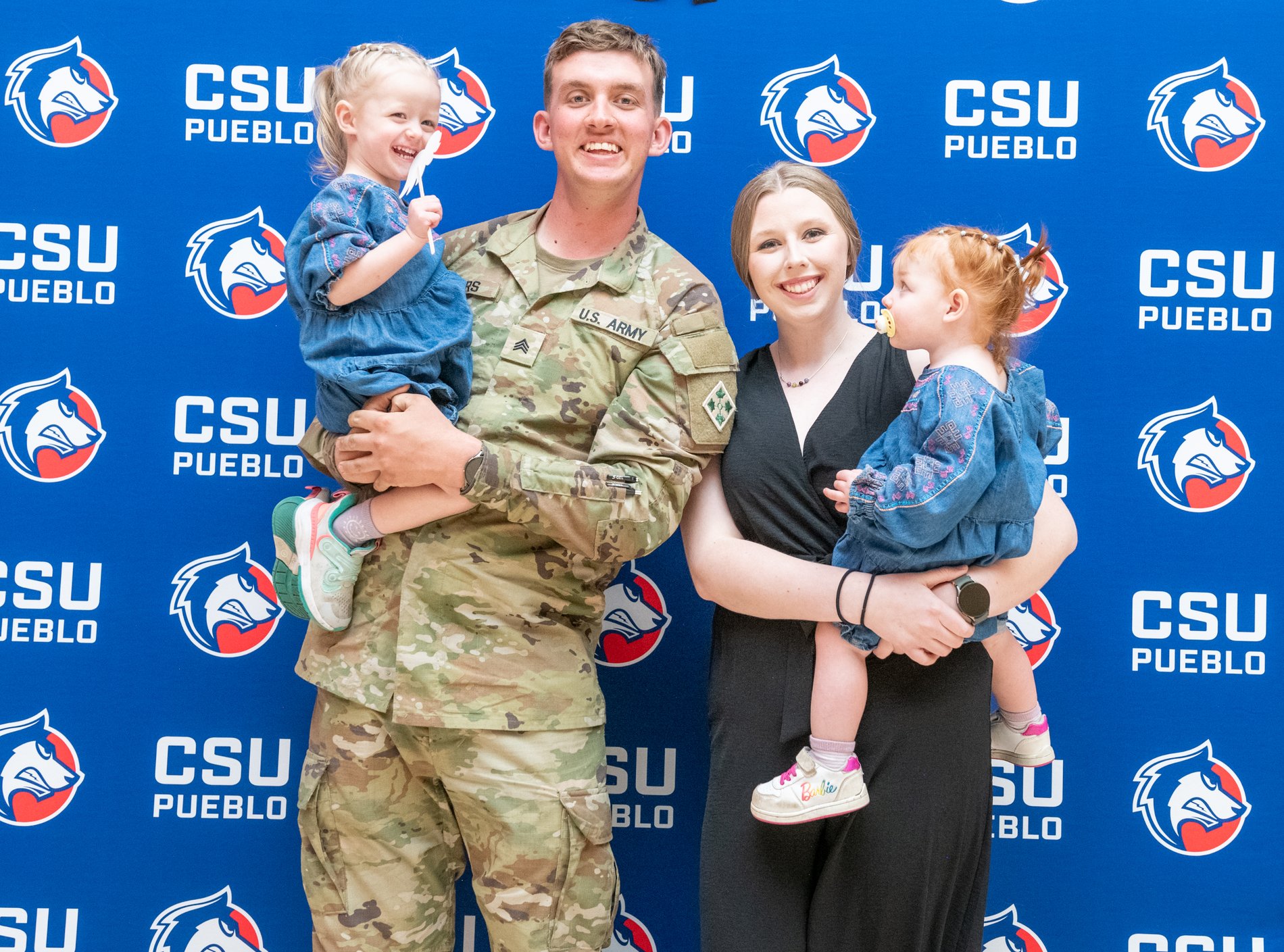 A soldier-graduate with family at a military graduation reception, CSU Pueblo