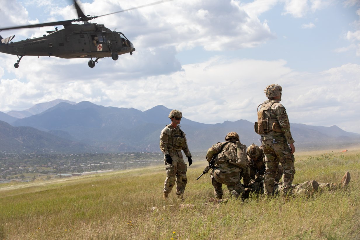 A Black Hawk lands beside soldiers on the Colorado plains