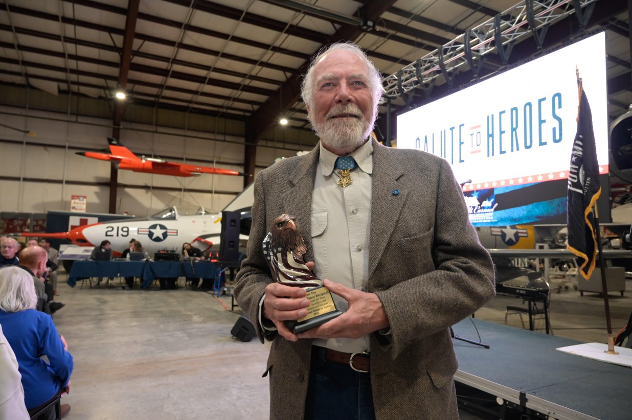 A veteran honored with an award in the hangar, Perfectionshoots military and veteran event photography
