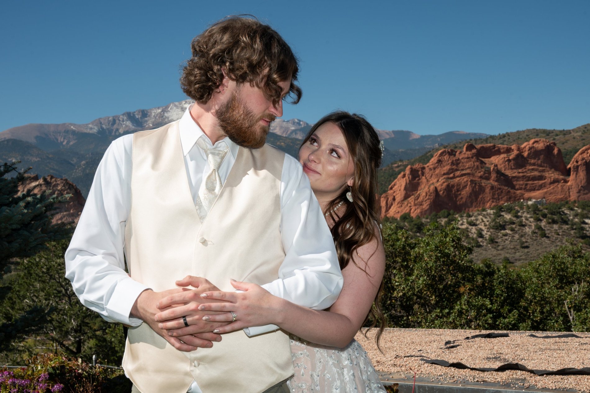 A bride gazing up at her groom before Pikes Peak and the red rock, Garden of the Gods Resort wedding, Perfectionshoots Colorado wedding photography