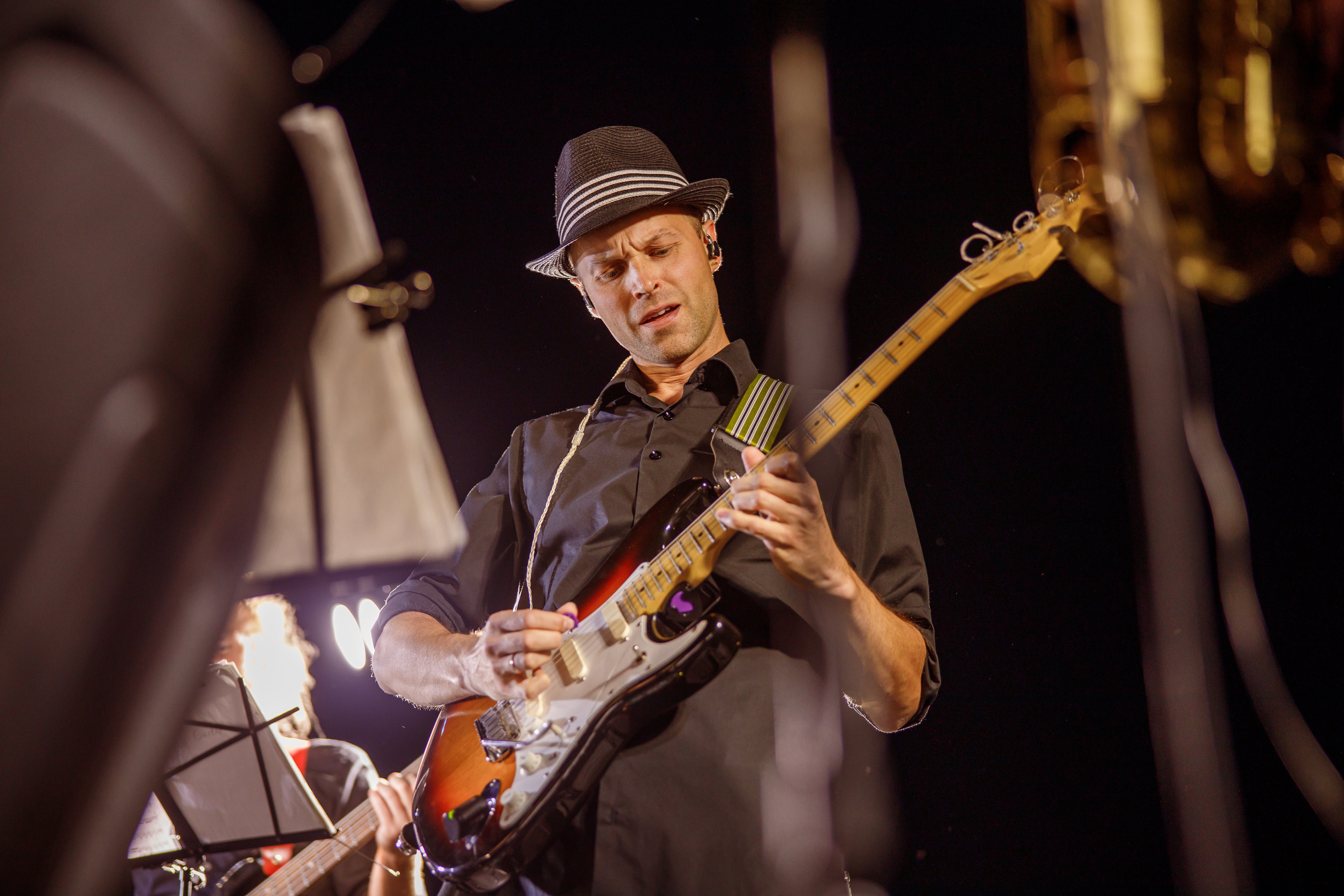 handsome-man-playing-guitar-at-night-outdoor-conce-2021-12-09-07-15-27-utc