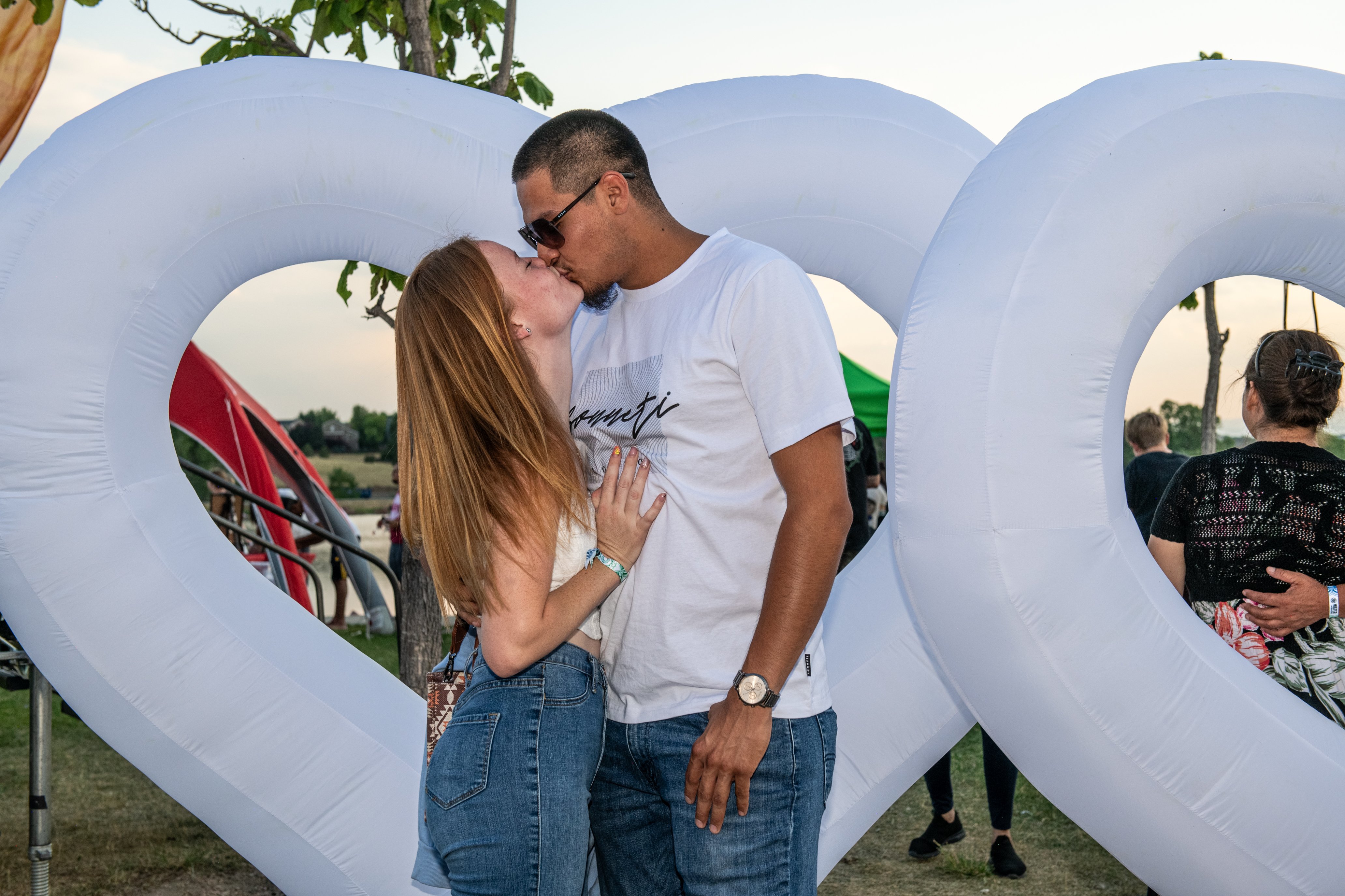 A kiss framed by a heart at the lantern festival, Perfectionshoots Colorado photography and cinematic film