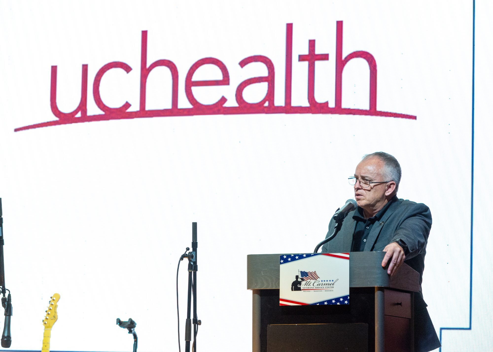 A healthcare leader at the podium, Perfectionshoots Colorado corporate event photography