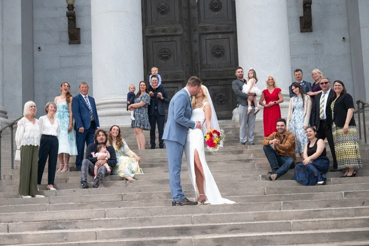 A wedding party celebrating together on the courthouse steps